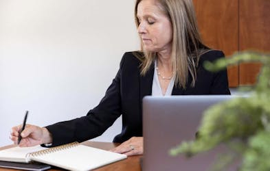Woman writing notes.